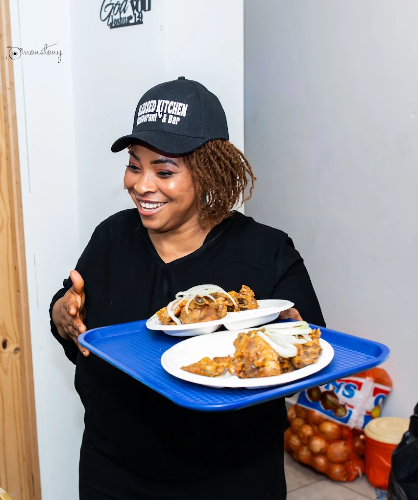 Waiter serving food at Blessed Kitchen